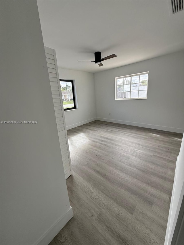 spare room featuring light hardwood / wood-style floors and ceiling fan