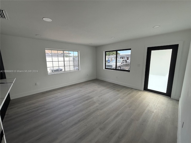 unfurnished living room with light hardwood / wood-style flooring and a healthy amount of sunlight