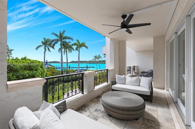 balcony with a water view and ceiling fan