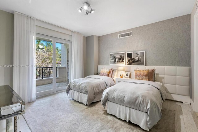 bedroom featuring light hardwood / wood-style floors and access to exterior