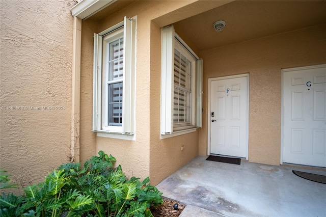 view of exterior entry featuring a patio