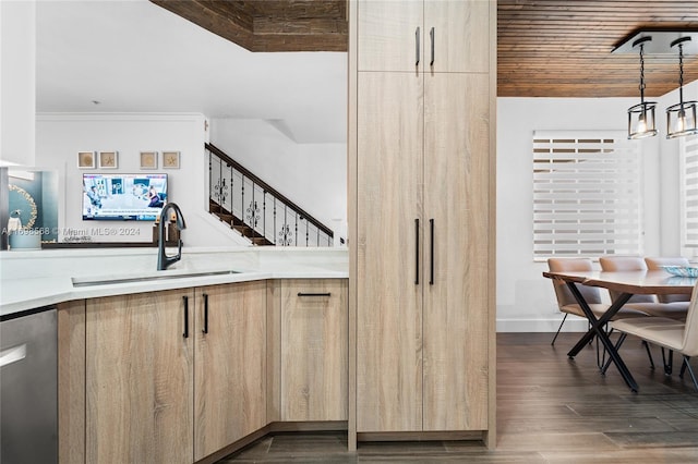 kitchen featuring sink, hanging light fixtures, dark wood-type flooring, stainless steel dishwasher, and light brown cabinetry