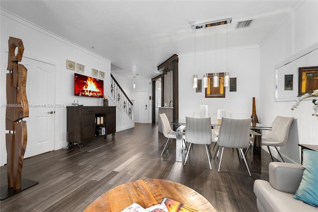 dining space with dark hardwood / wood-style floors and crown molding