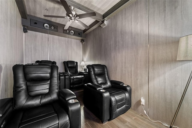 home theater featuring hardwood / wood-style floors, ceiling fan, and crown molding