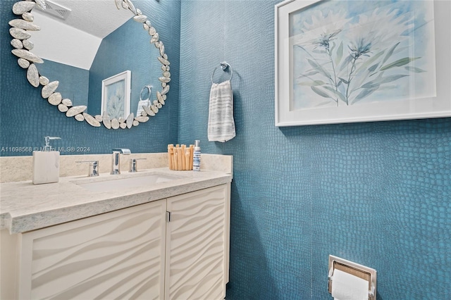 bathroom with vanity and a textured ceiling