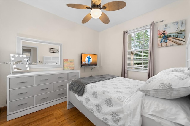 bedroom with ceiling fan and hardwood / wood-style flooring