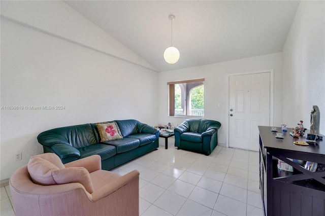 living room featuring light tile patterned flooring and vaulted ceiling