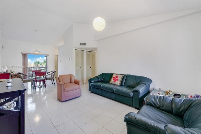 tiled living room with high vaulted ceiling