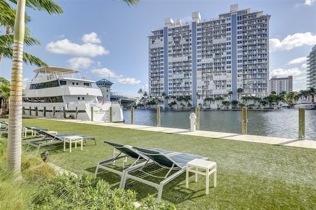 view of dock featuring a yard and a water view