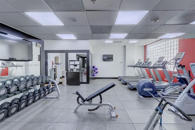 gym with a paneled ceiling