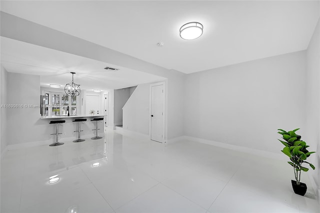 interior space with an inviting chandelier and tile patterned floors