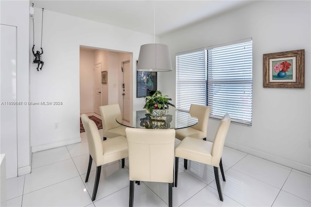 dining space featuring light tile patterned flooring