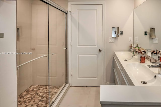 bathroom featuring vanity, tile patterned floors, and a shower with door