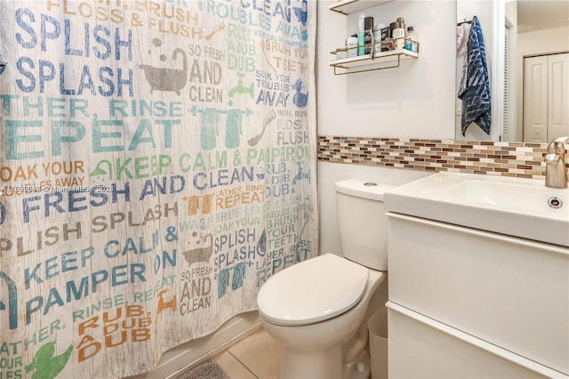 bathroom with tasteful backsplash, tile patterned flooring, vanity, and toilet