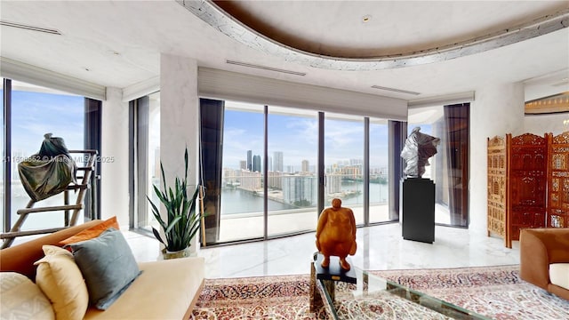 living room featuring floor to ceiling windows and a water view