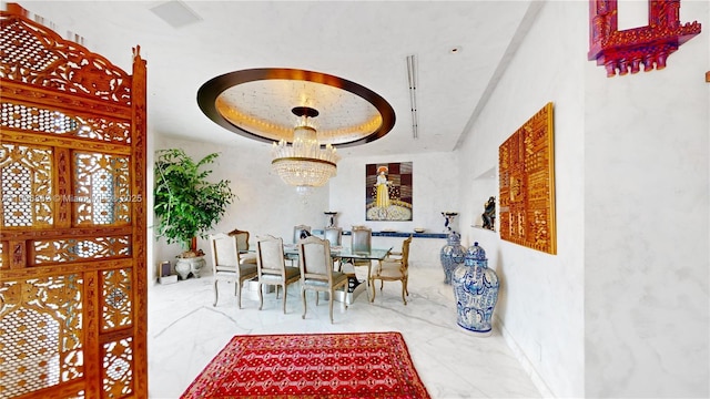 dining area featuring a tray ceiling and an inviting chandelier