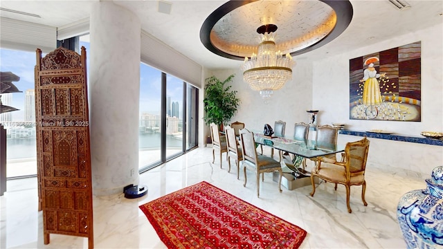 dining room featuring a raised ceiling and an inviting chandelier