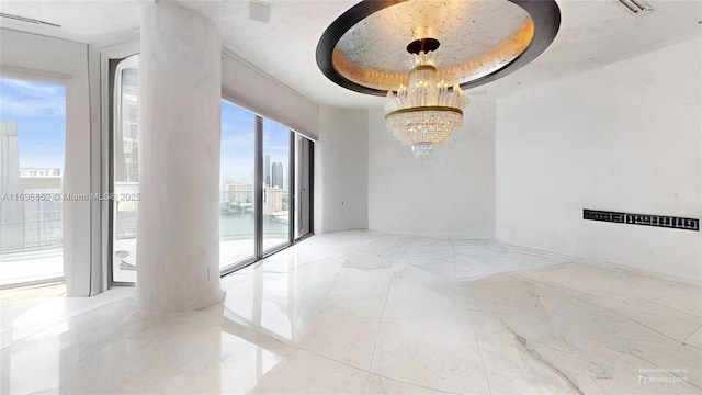 unfurnished room featuring an inviting chandelier