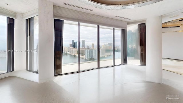 empty room with a water view and expansive windows