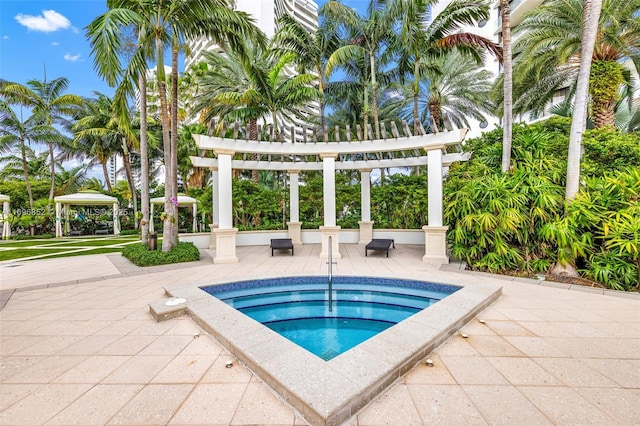 view of pool with an in ground hot tub