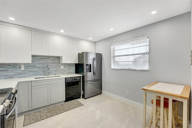 kitchen with decorative backsplash, stainless steel appliances, and sink