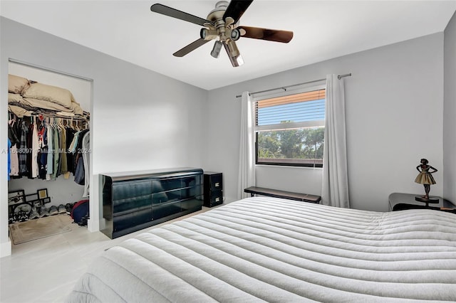 bedroom featuring ceiling fan, a walk in closet, and a closet