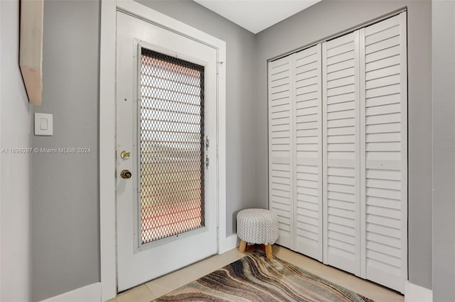 doorway featuring light tile patterned floors