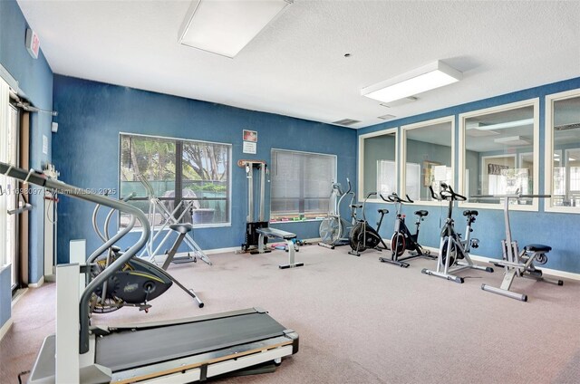 exercise room with a textured ceiling