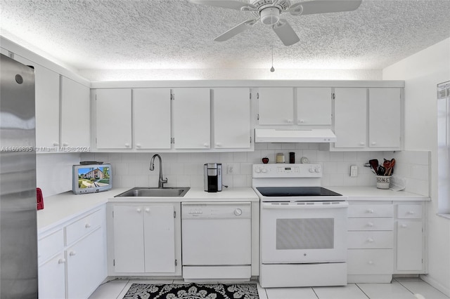 kitchen featuring backsplash, sink, white cabinets, and white appliances