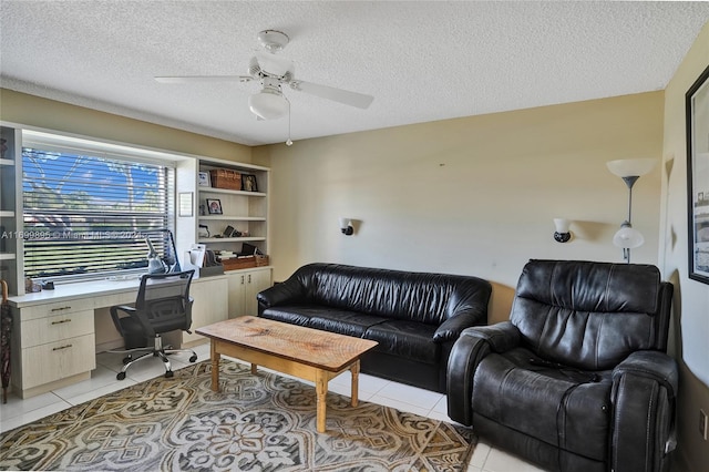 tiled home office featuring a textured ceiling and ceiling fan