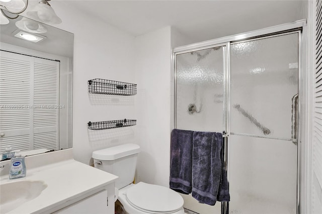 bathroom with vanity, toilet, and walk in shower