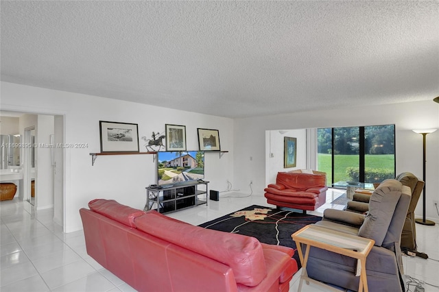 living room featuring light tile patterned flooring and a textured ceiling