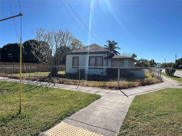 bungalow-style home with a front lawn