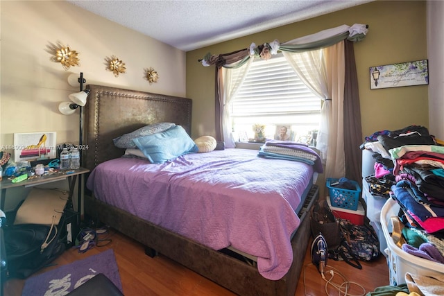 bedroom with wood-type flooring and a textured ceiling