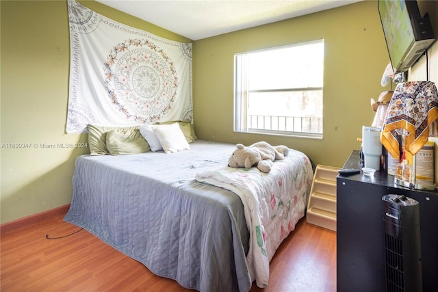 bedroom featuring hardwood / wood-style floors and a textured ceiling