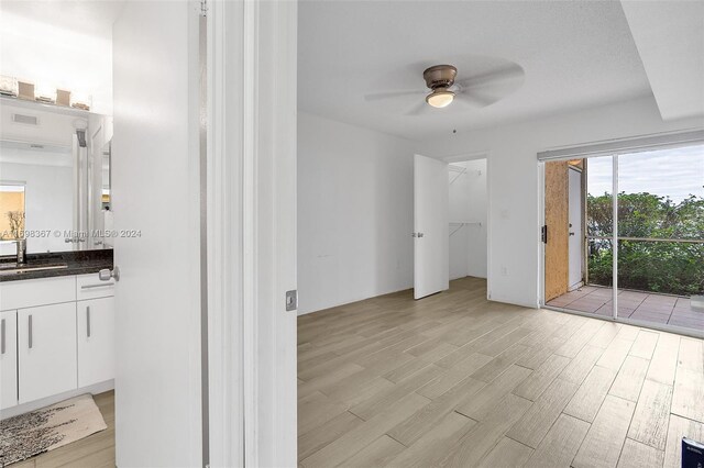 interior space with ceiling fan, vanity, and hardwood / wood-style flooring