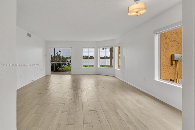 unfurnished room with light hardwood / wood-style floors