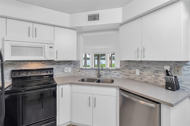 kitchen featuring sink, electric range, stainless steel dishwasher, tasteful backsplash, and white cabinetry