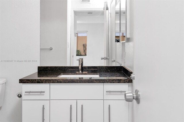 bathroom with vanity and toilet