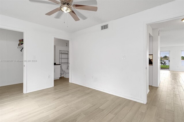 empty room featuring light wood-type flooring and ceiling fan