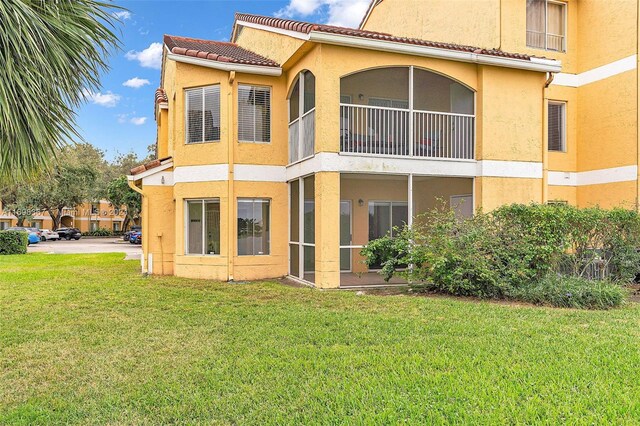 rear view of house with a yard