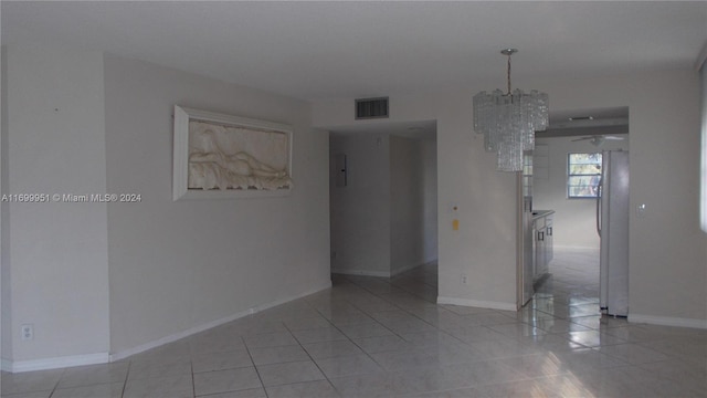 tiled empty room with ceiling fan with notable chandelier and electric panel