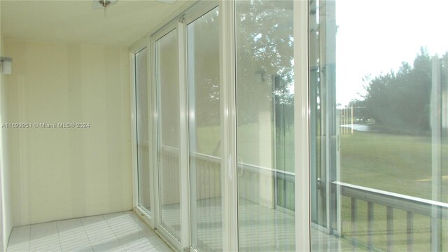 unfurnished sunroom featuring a water view