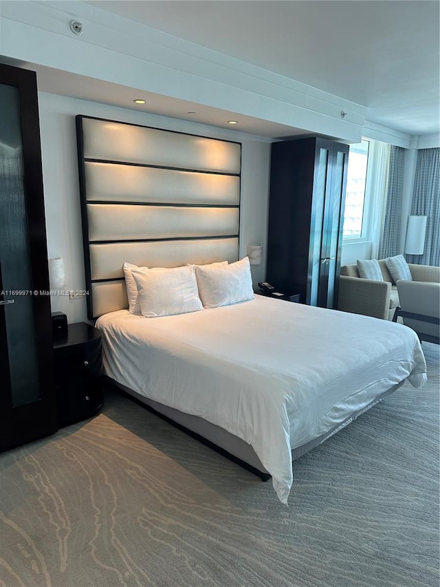 bedroom featuring dark colored carpet