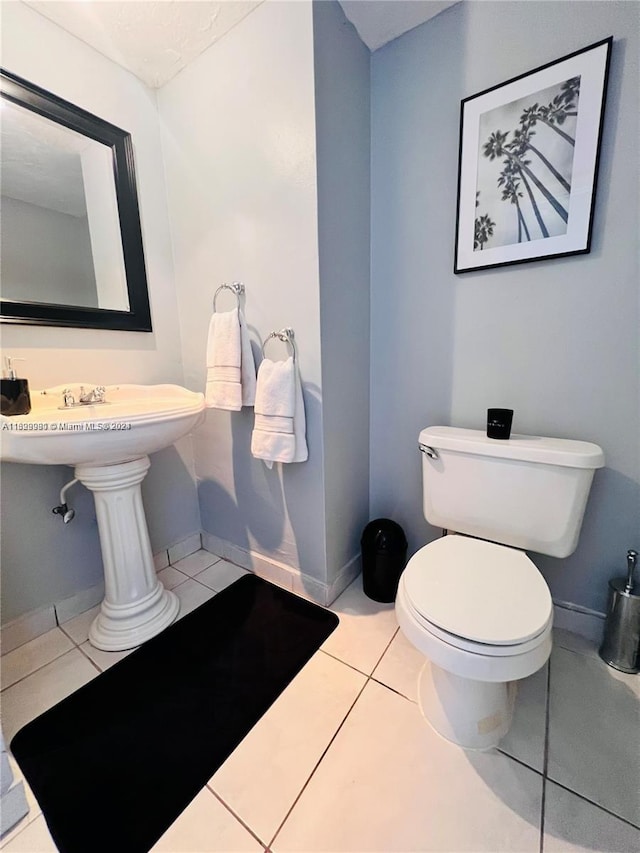 bathroom featuring toilet and tile patterned floors