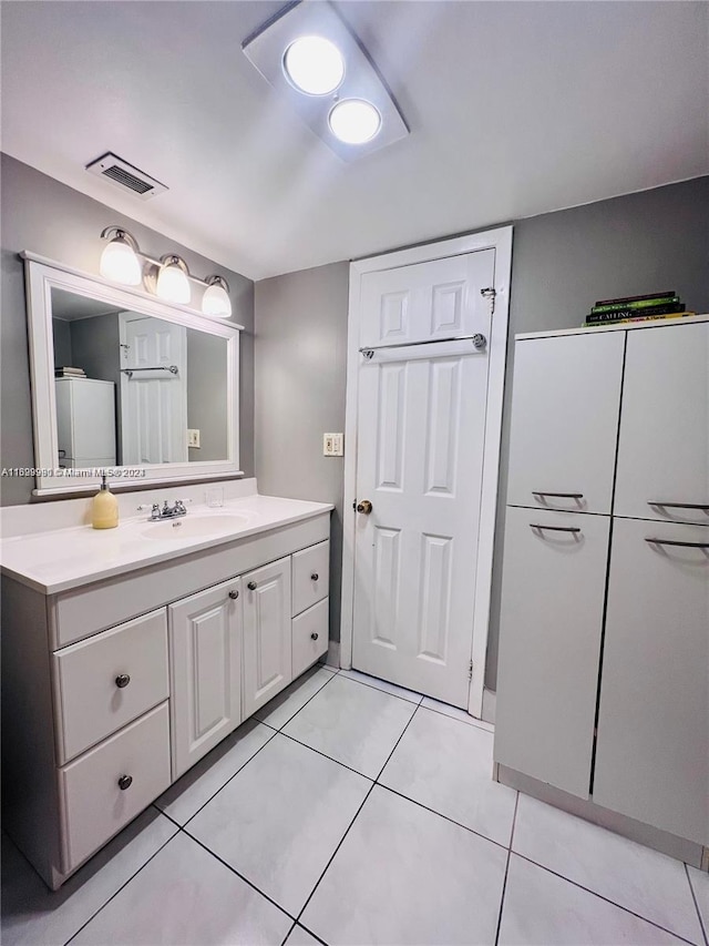 bathroom with tile patterned flooring and vanity