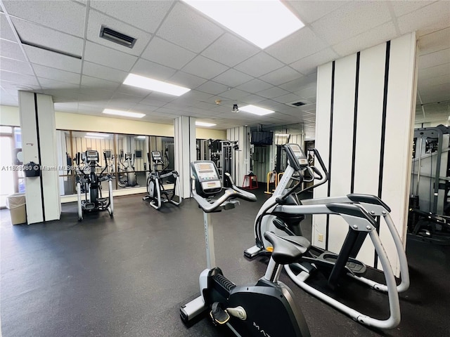 gym with a paneled ceiling