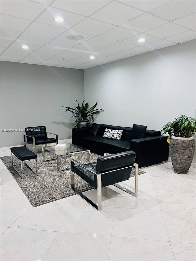 living room featuring a paneled ceiling