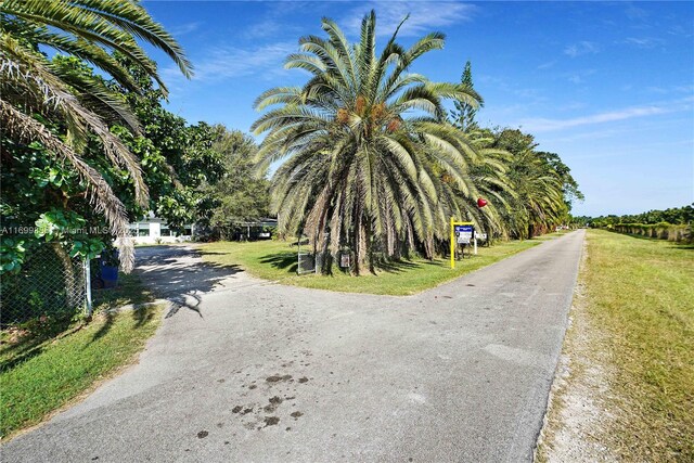 single story home with a carport, a garage, and a front yard