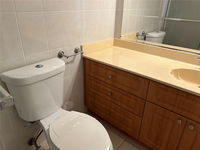 bathroom with tile patterned flooring, vanity, and tile walls